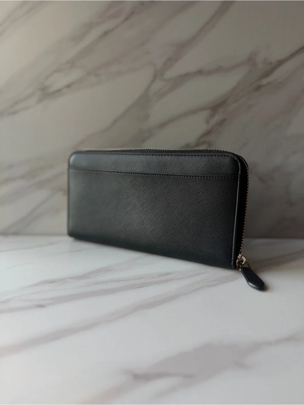 Kate Spade black saffiano leather zip-around continental wallet.